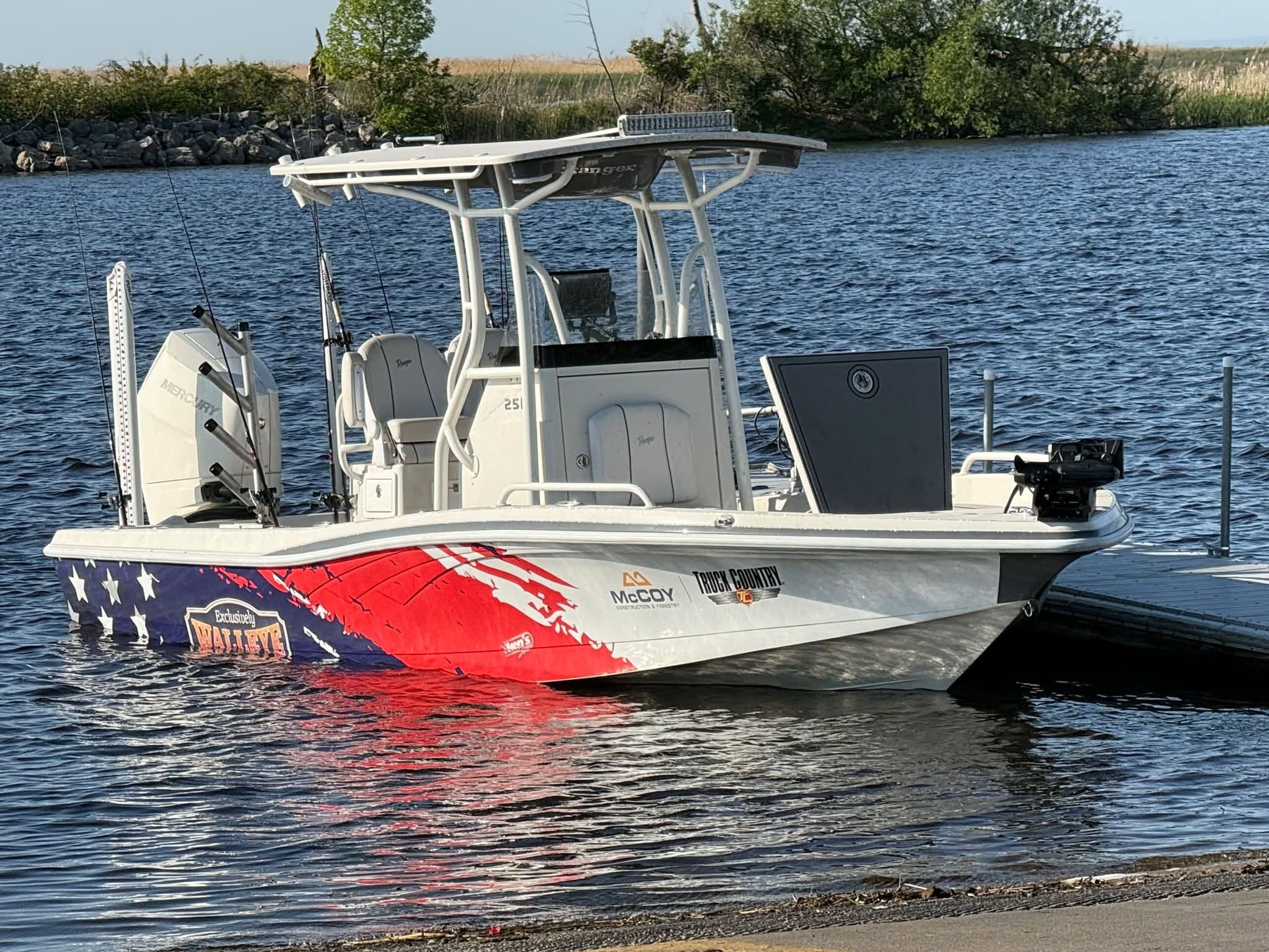 Exclusively Walleye charter boat with its red white and blue wrap at the dock