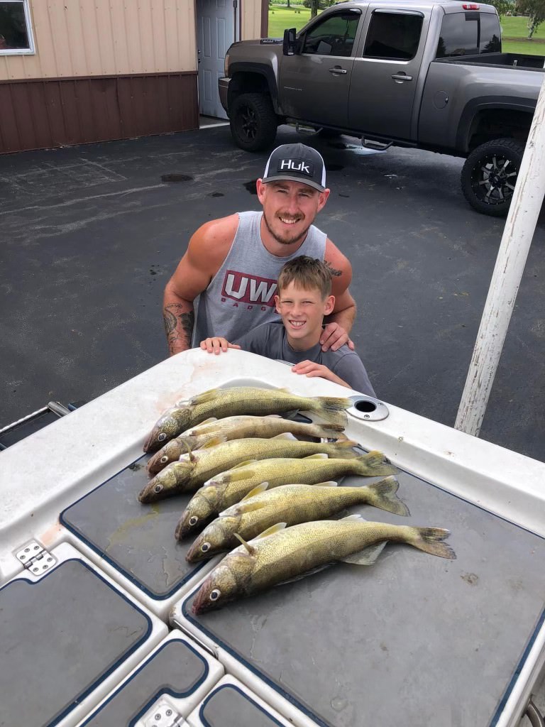 Father and son with their walleye catches at the end of an Exclusively Walleye fishing trip